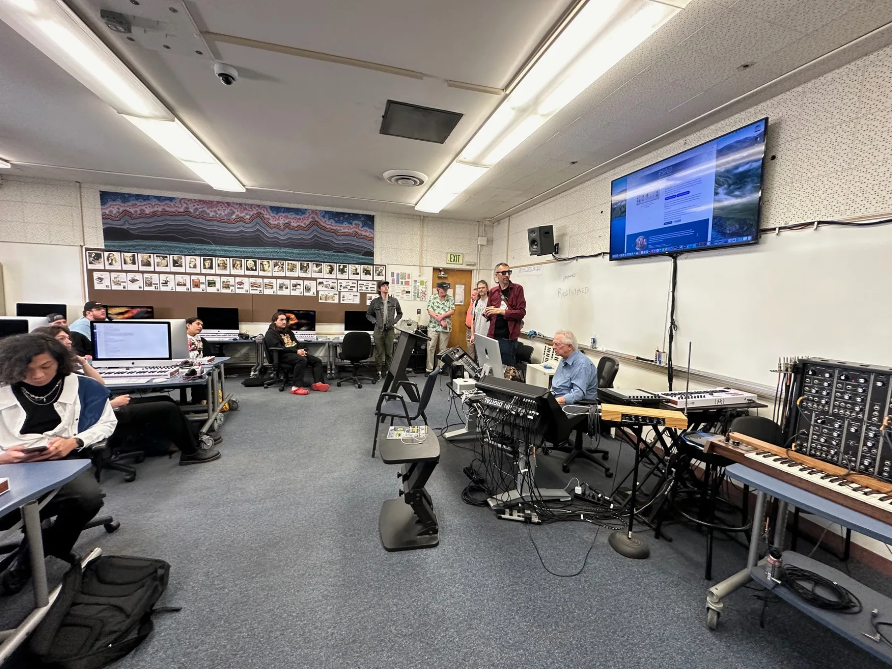 Music technology classroom with students and instruments