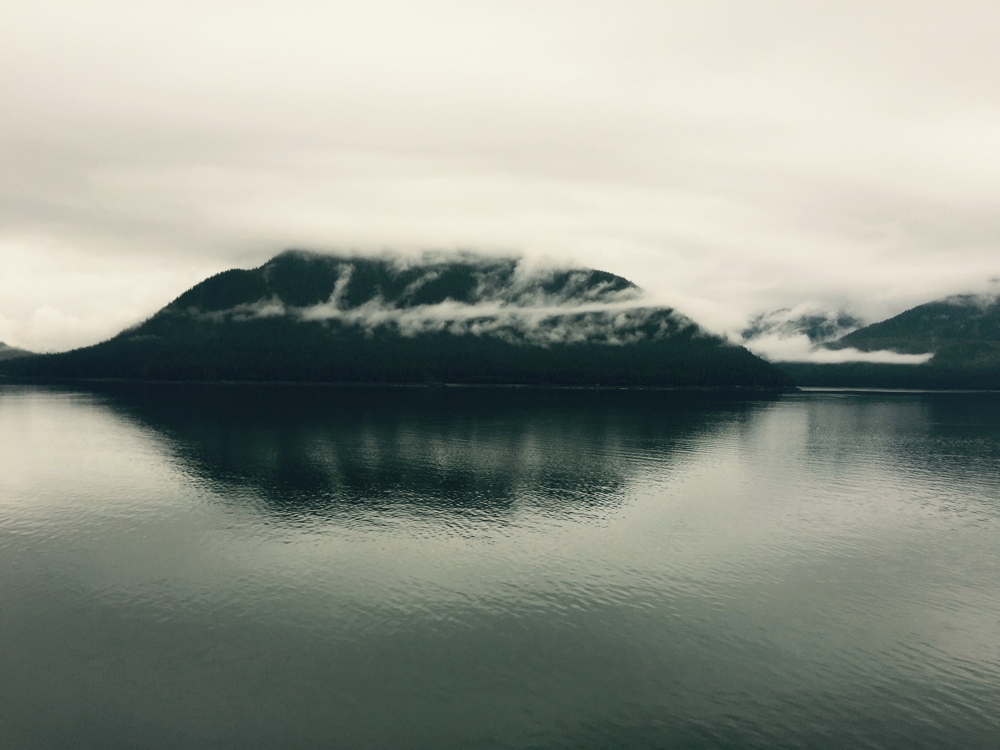 Quiet coastline beneath low clouds