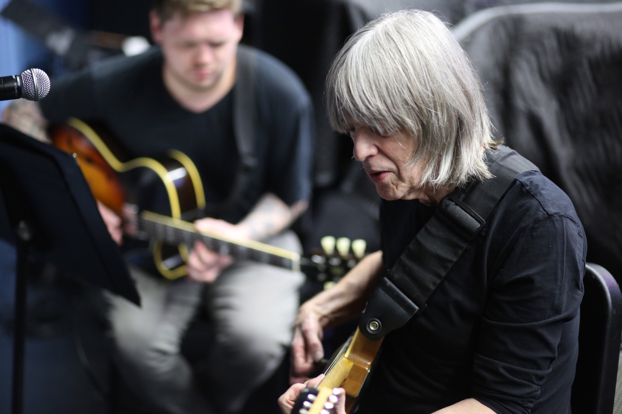Guitarist with instrument in a candid performance setting