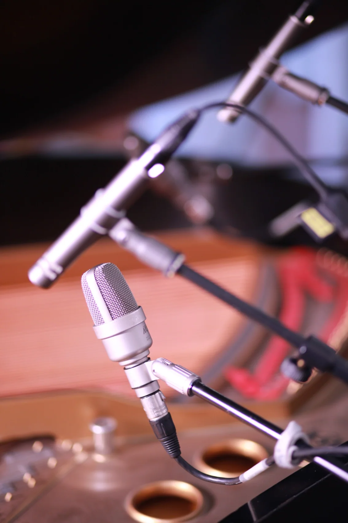 Microphones placed above a piano during recording